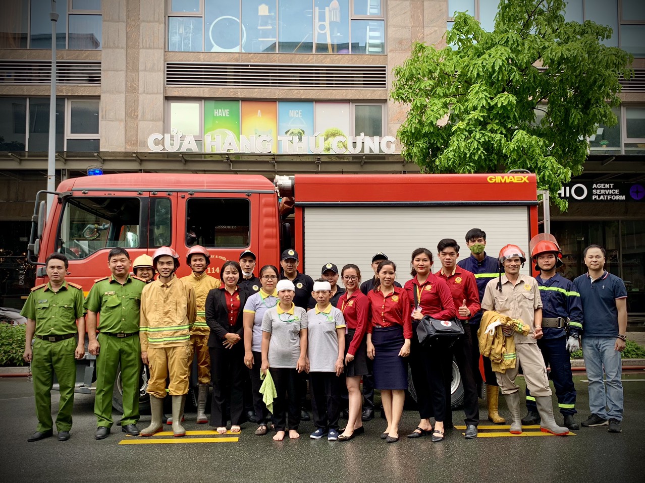 A group of people posing for a photo in front of a firetruckDescription automatically generated